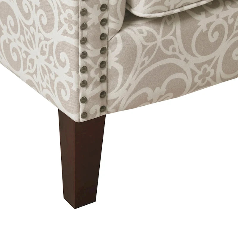 Fauteuil club capitonné avec motif de frettes et clous décoratifs argentés